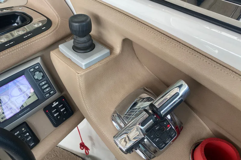 Slide: The Image of Interior controls of a 2010 Cobalt 302 boat, featuring joystick and navigation display. - 31