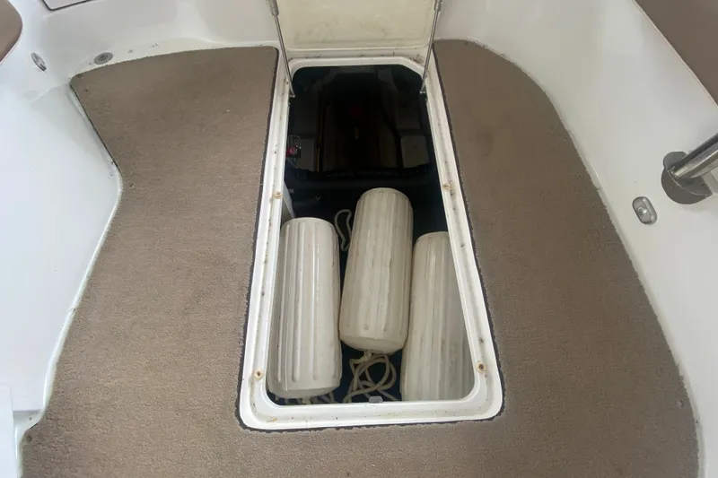 Slide: The Image of Storage compartment on a 2010 Cobalt 302 boat with fenders and ropes. - 40