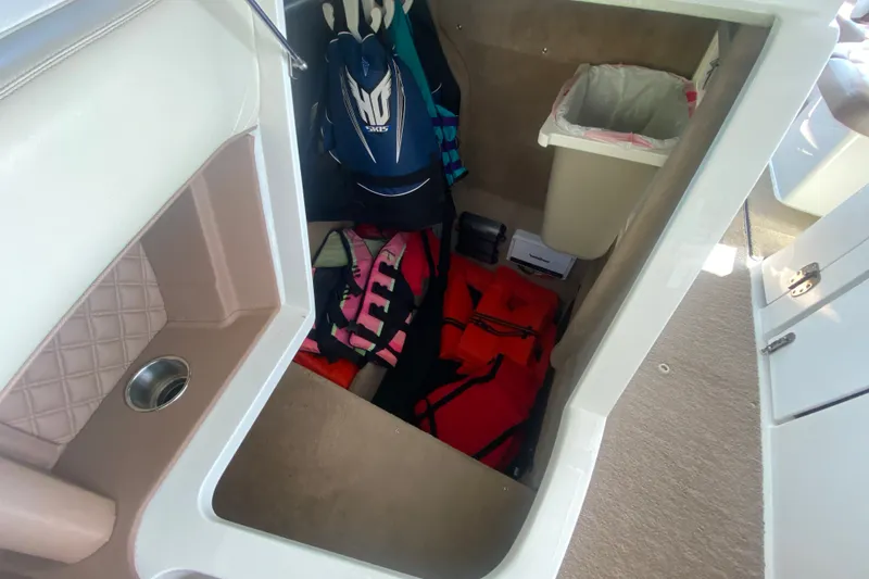 Slide: The Image of Storage compartment in a 2010 Cobalt 302 boat with life jackets and equipment. - 36