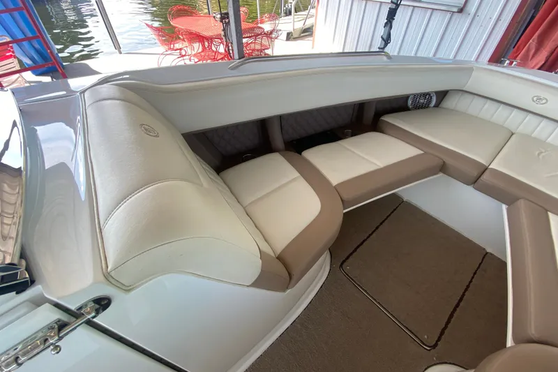 Slide: The Image of Interior of a 2010 Cobalt 302 boat with beige and white seating. - 34