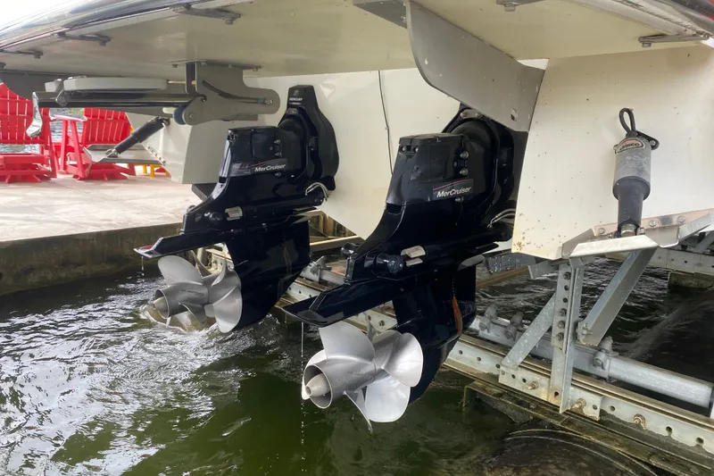 Slide: The Image of Twin MerCruiser outboard motors on a 2010 Cobalt 302 boat at a dock. - 47