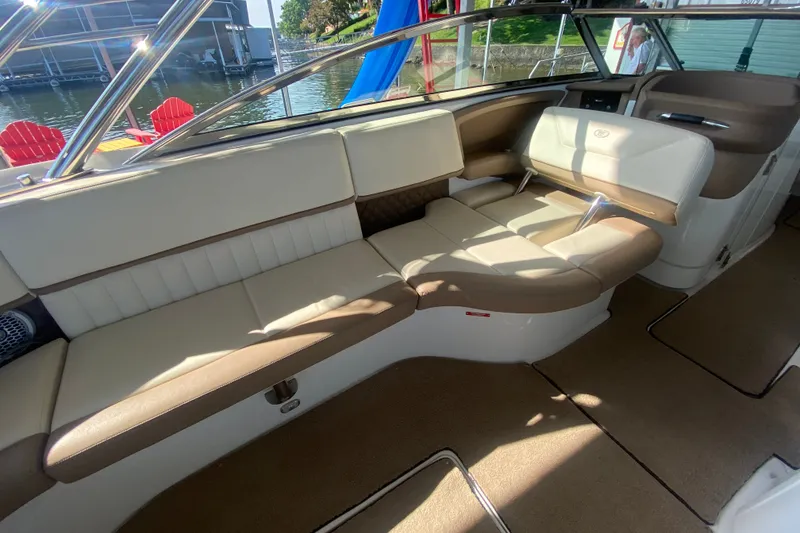 Slide: The Image of Luxurious interior of a 2010 Cobalt 302 boat with beige seating and waterfront view. - 16