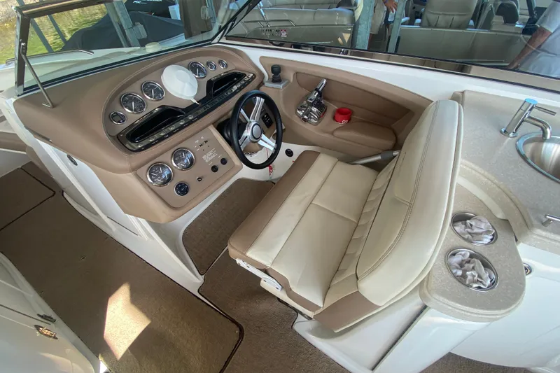 Slide: The Image of Interior of a 2010 Cobalt 302 boat with steering wheel and dashboard controls. - 17