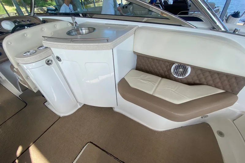Slide: The Image of Interior of a 2010 Cobalt 302 boat featuring a sink and cushioned seating. - 15