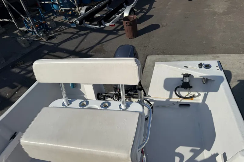 Slide: The Image of 2016 Allied 15 Sportsman boat interior with white seating and motor controls. - 9