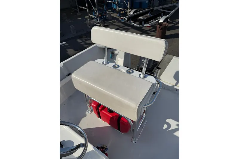 Slide: The Image of 2016 Allied 15 Sportsman boat seat with storage and red fuel tank. - 6