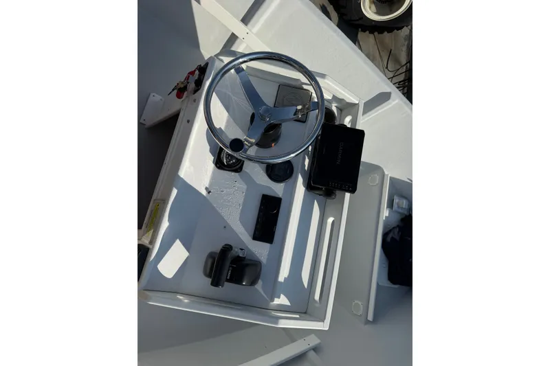 Slide: The Image of The image shows a boat's helm with a steering wheel and instruments. - 10