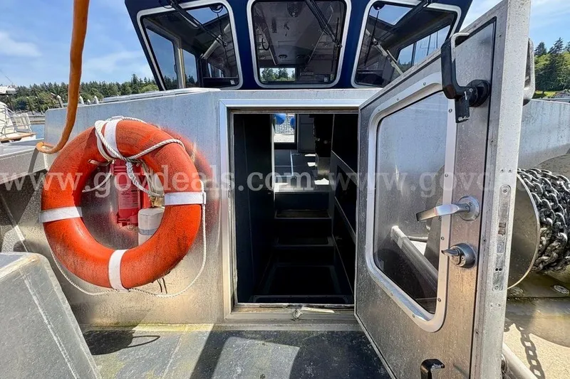 Slide: The Image of 2019 Armstrong Marine 38 Monohull boat with open cabin door and life preserver. - 17