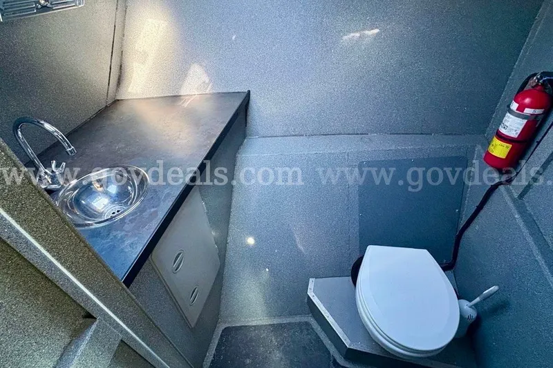 Slide: The Image of Compact bathroom in 2019 Armstrong Marine 38 Monohull with sink, toilet, and fire extinguisher. - 45