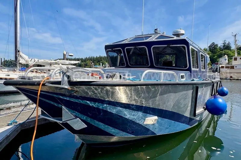 Slide: The Image of 2019 Armstrong Marine 38 Monohull boat docked in a marina, featuring a sleek design. - 6