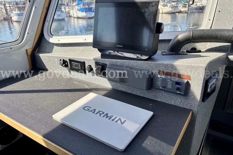 Slide: The Image of Armstrong Marine 38 Monohull 2019 cockpit with Garmin navigation system, docked at marina. - 38