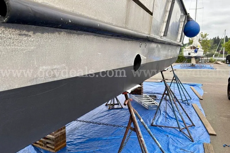 Slide: The Image of 2019 Armstrong Marine 38 Monohull on stands, undergoing maintenance with blue tarps underneath. - 57