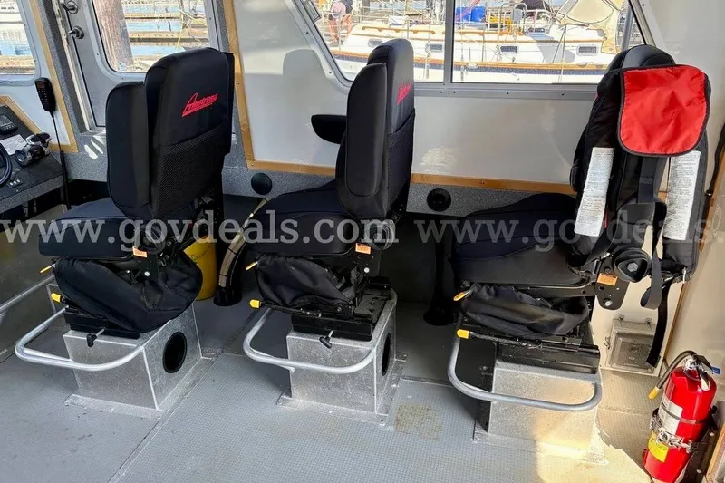 Slide: The Image of Interior of 2019 Armstrong Marine 38 Monohull with three black seats and a fire extinguisher. - 26