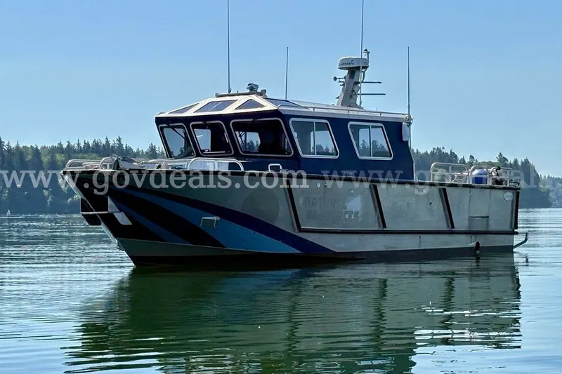 Slide: The Image of 2019 Armstrong Marine 38 Monohull boat on calm water, forested shoreline in background. - 1