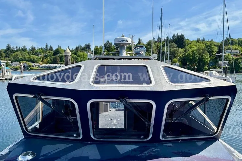 Slide: The Image of 2019 Armstrong Marine 38 Monohull boat with modern cabin design, docked in a scenic marina. - 19