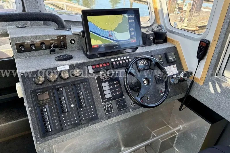 Slide: The Image of Control panel of a 2019 Armstrong Marine 38 Monohull with navigation display and steering wheel. - 32