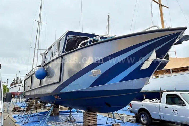 Slide: The Image of 2019 Armstrong Marine 38 Monohull boat on dry dock, blue and silver design. - 58