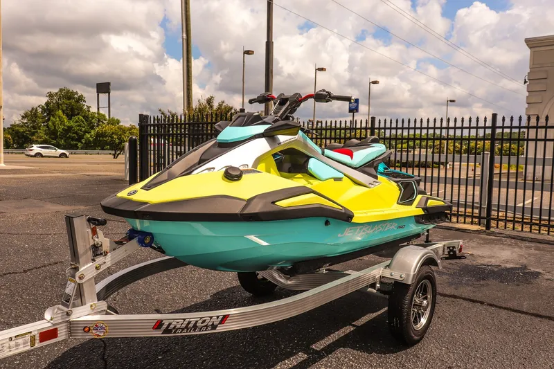 The Image of 2025 Yamaha WaveRunner JetBlaster PRO 3-Up on trailer, vibrant yellow and teal design. - 1