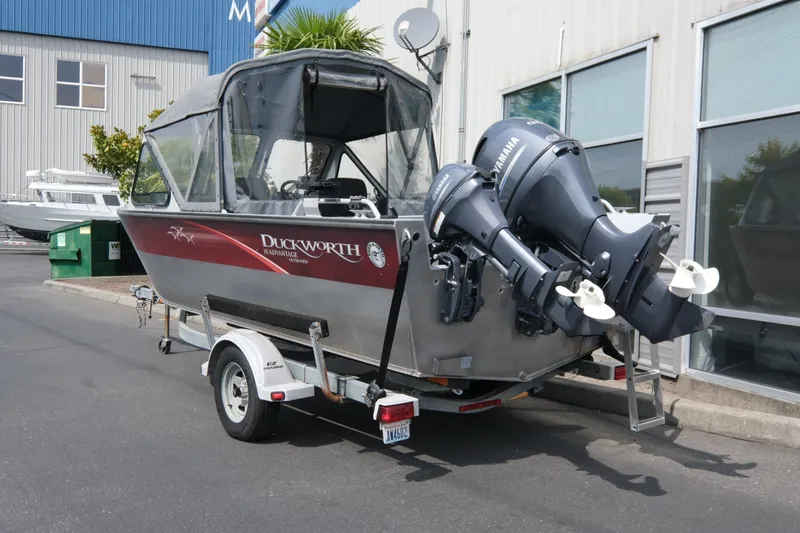 Slide: The Image of 2018 Duckworth 18 Advantage Outboard boat on trailer, parked outside a building. - 3