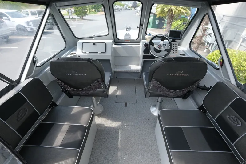 Slide: The Image of Interior of a 2018 Duckworth 18 Advantage Outboard boat, featuring seating and steering console. - 8
