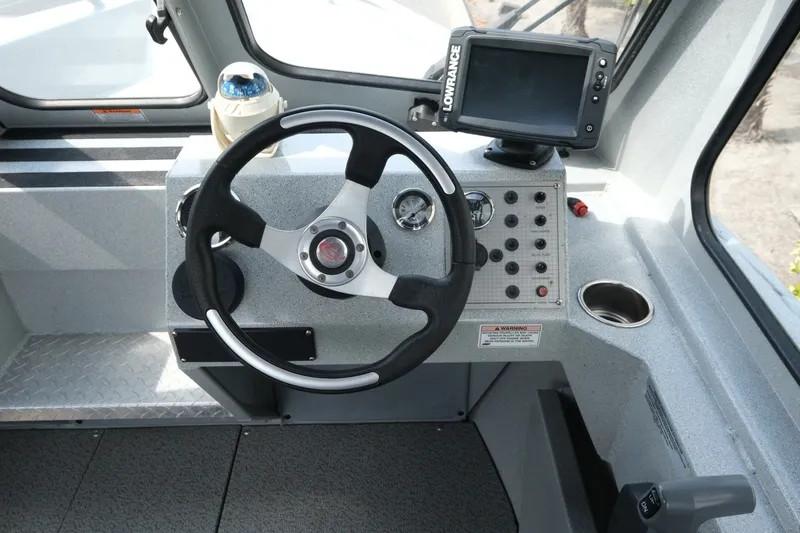 Slide: The Image of 2018 Duckworth 18 Advantage Outboard boat dashboard with steering wheel and navigation system. - 12
