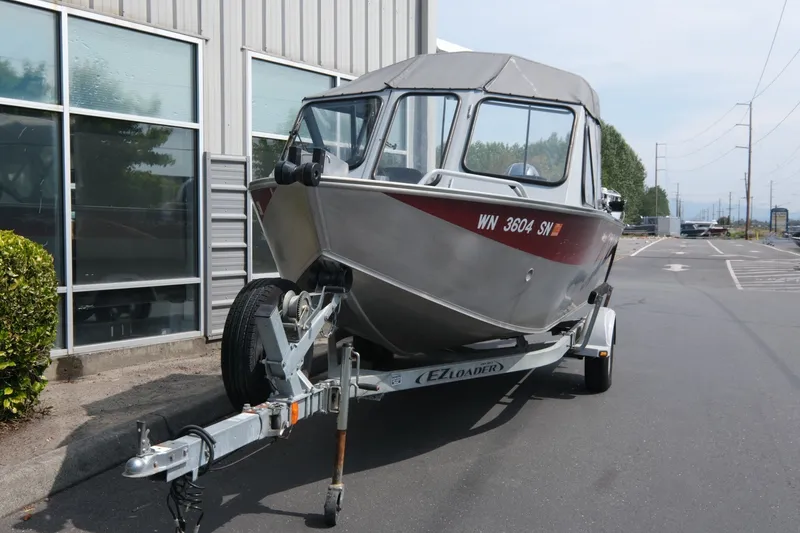 Slide: The Image of 2018 Duckworth 18 Advantage Outboard boat on trailer near industrial building. - 4