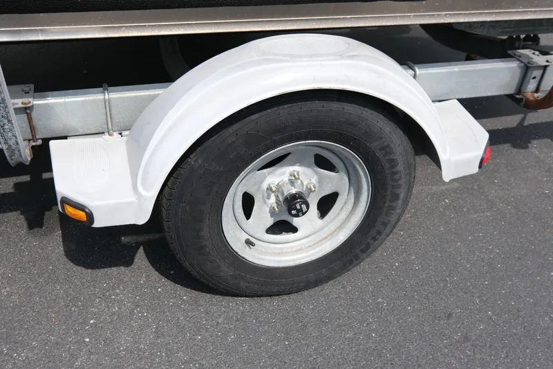 Slide: The Image of Trailer wheel of a 2018 Duckworth 18 Advantage Outboard on asphalt. - 14