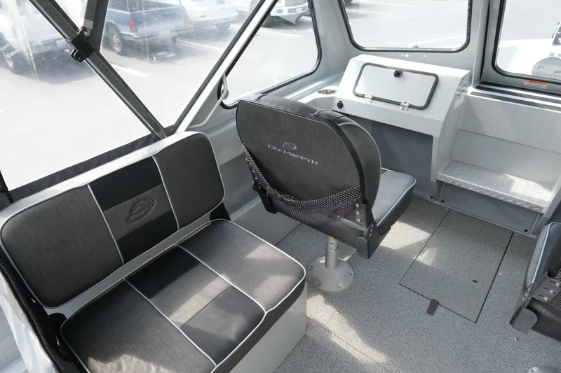 Slide: The Image of Interior of a 2018 Duckworth 18 Advantage Outboard boat with seating and dashboard. - 9