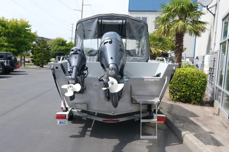 Slide: The Image of 2018 Duckworth 18 Advantage Outboard boat with dual engines in a parking lot. - 5