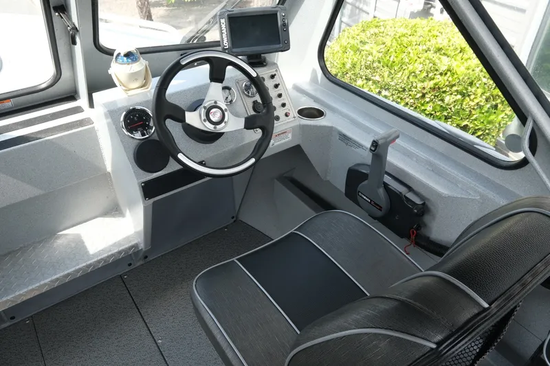 Slide: The Image of Interior of a 2018 Duckworth 18 Advantage Outboard boat, featuring steering wheel and control panel. - 11