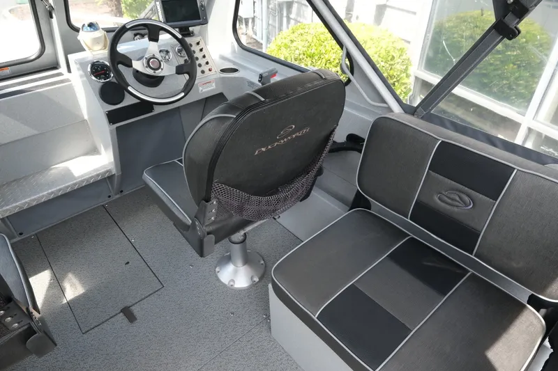 Slide: The Image of Interior of a 2018 Duckworth 18 Advantage Outboard boat, featuring steering and seating. - 10