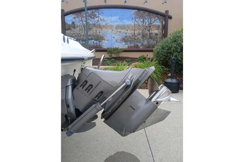 Slide: The Image of 2003 Larson SEi 180 boat with Volvo Penta outdrive, outdoor setting with mural background. - 5