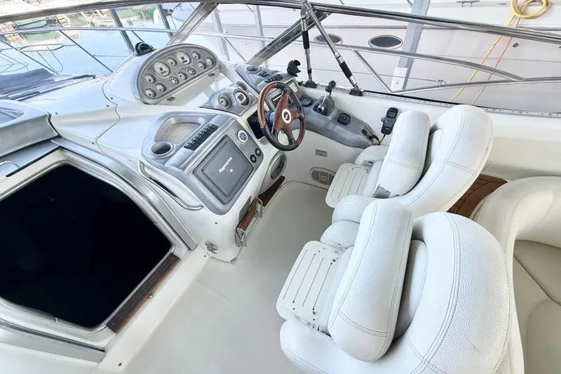 Slide: The Image of 2005 Cranchi Endurance 41 yacht cockpit with steering wheel and control panel. - 9