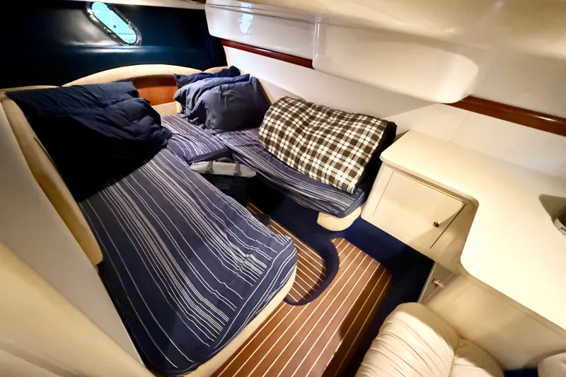 Slide: The Image of Cozy cabin interior of 2005 Cranchi Endurance 41 yacht with striped bedding. - 34