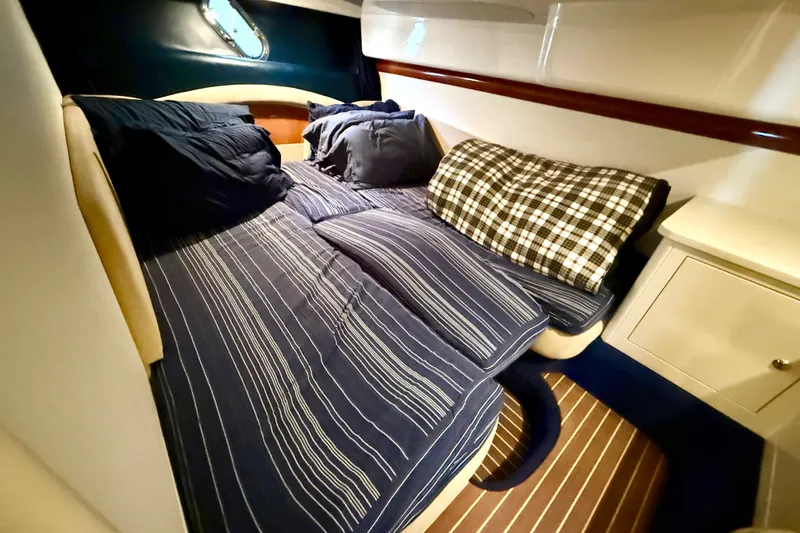 Slide: The Image of Cozy cabin interior of 2005 Cranchi Endurance 41 with striped bedding and cushions. - 35
