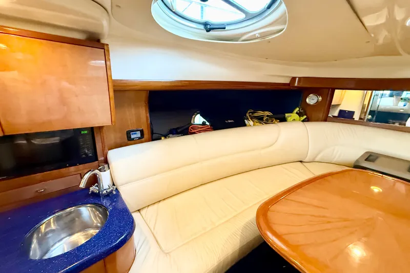 Slide: The Image of Interior of 2005 Cranchi Endurance 41 yacht with plush seating and kitchenette. - 24