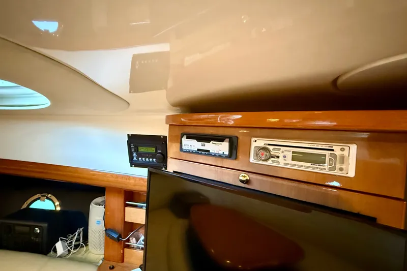 Slide: The Image of Interior of 2005 Cranchi Endurance 41 yacht with audio system and wooden cabinetry. - 37