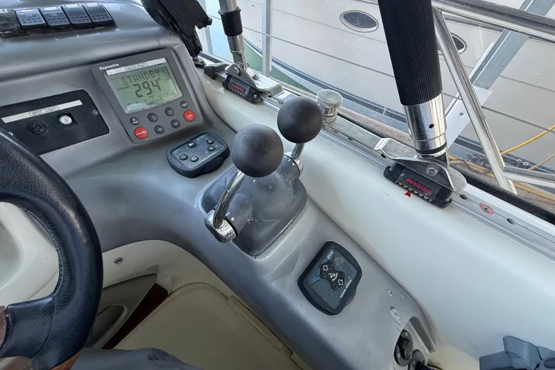 Slide: The Image of Control panel of a 2005 Cranchi Endurance 41 boat with steering wheel and navigation instruments. - 14