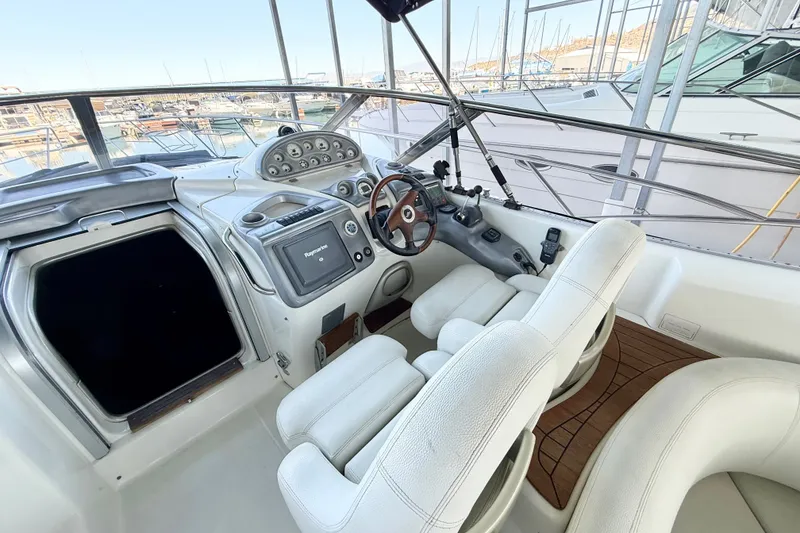 Slide: The Image of Cockpit of 2005 Cranchi Endurance 41 yacht with modern controls and white seating. - 6
