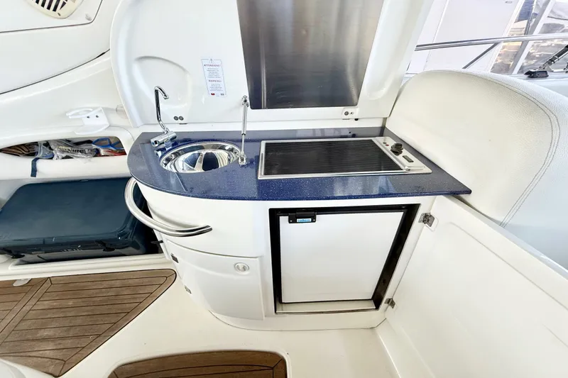Slide: The Image of 2005 Cranchi Endurance 41 yacht kitchenette with sink, stove, and mini fridge. - 18