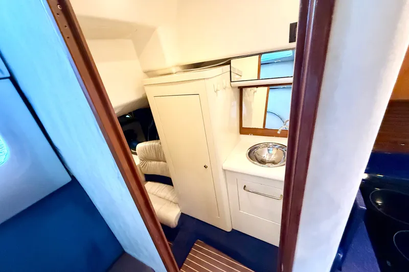 Slide: The Image of Interior of 2005 Cranchi Endurance 41 yacht, featuring compact kitchenette and seating area. - 29