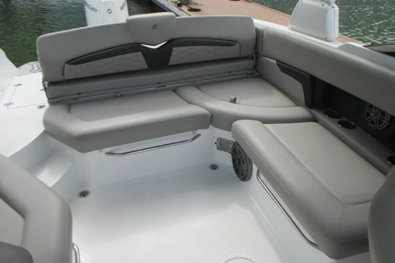 Slide: The Image of 2022 Four Winns HD8 OB boat interior with gray seating and cup holders. - 12