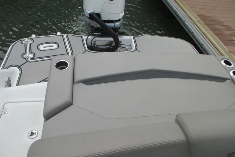 Slide: The Image of 2022 Four Winns HD8 OB boat with sleek seating and outboard motor. - 7