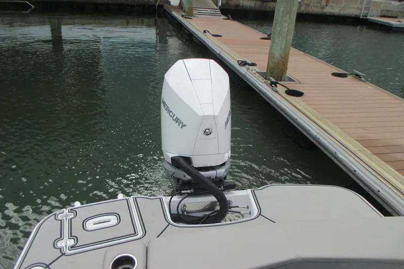 Slide: The Image of 2022 Four Winns HD8 OB boat with Mercury outboard engine docked at marina. - 6