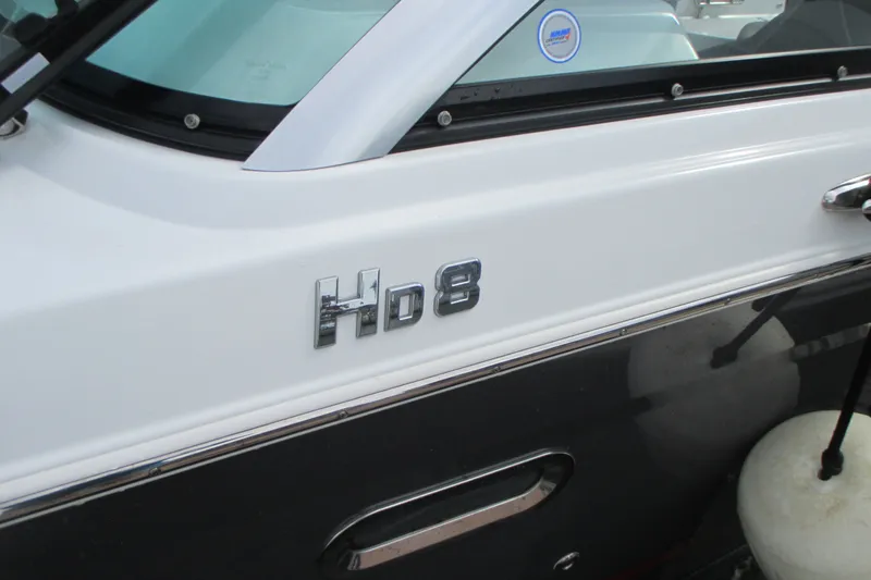 Slide: The Image of 2022 Four Winns HD8 OB boat side view with model emblem. - 2