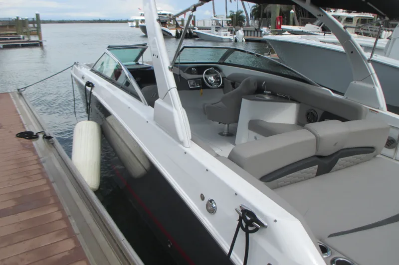 Slide: The Image of 2022 Four Winns HD8 OB boat docked, showcasing sleek design and spacious seating. - 4