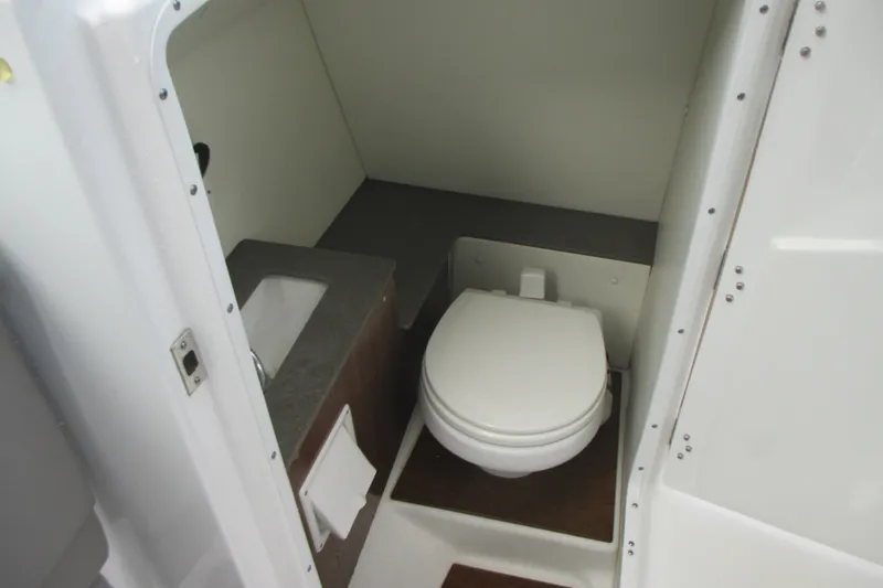 Slide: The Image of 2022 Four Winns HD8 OB boat bathroom with toilet and sink. - 17