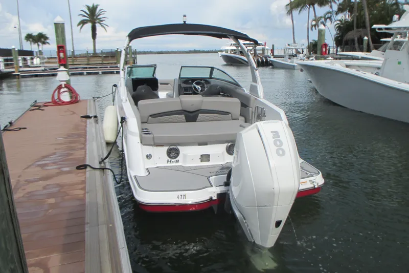 Slide: The Image of 2022 Four Winns HD8 OB boat docked at marina with outboard motor. - 3