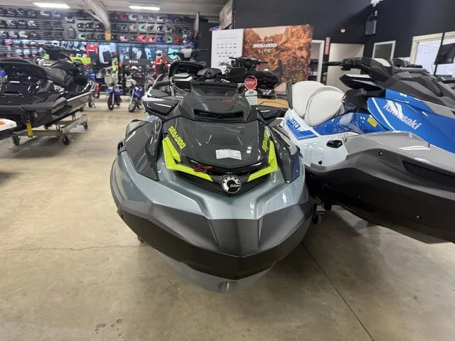 Slide: The Image of A 2026 Sea-Doo RXT-X jet ski is displayed in a showroom alongside other watercraft. - 3