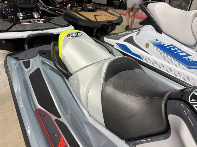 Slide: The Image of A modern Sea-Doo RXT-X jet ski with a gray and black seat, displayed in a showroom. - 10